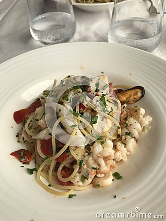 Plate of seafood â€˜spaghetti allo scoglioâ€™ pasta in a restaurant on the Italian Riviera Stock Photo